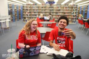 Students pose for photo in library